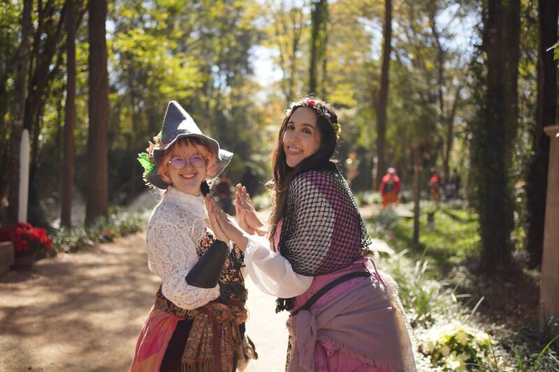 Two friends in Renaissance faire costume among trees